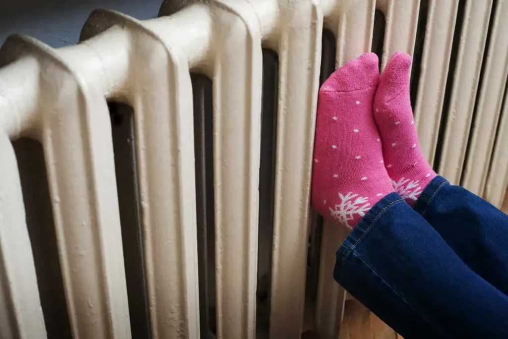 Warming Feet On Heating Radiator