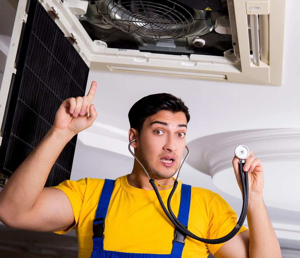 Repairman repairing ceiling ac unit